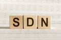 Wooden cubes with word SDN - abbreviation Software Defined Networking on white background Royalty Free Stock Photo