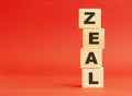 Wooden cubes with word ZEAL. Wooden cubes on a red background. Free space on the left