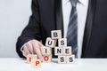 Wooden cubes with words business and IPO, business IPO concept, businesman in suit