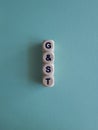 Wooden cubes with words GST on blue background. State financial policy to regulate tax collection rules and reduce bureaucratic