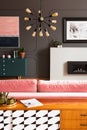 Cupboard in grey living room interior with lamp, green cabinet and poster above fireplace