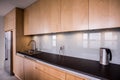 Wooden cupboards and black worktop