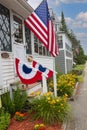 Wooden cute house decorated with flags and flowers. USA. Independence Day, July 4th. Royalty Free Stock Photo