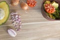 Wooden cutting board with fresh onions, tomatoes and avocado Royalty Free Stock Photo