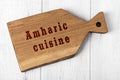 Wooden cutting board with inscription. Concept of amharic cuisine