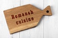 Wooden cutting board with inscription. Concept of romansh cuisine