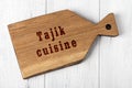 Wooden cutting board with inscription. Concept of tajik cuisine Royalty Free Stock Photo
