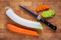 Wooden cutting board with knife, chopped leek and carrot Royalty Free Stock Photo