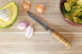 Wooden cutting board with knife, fresh onions and avocado Royalty Free Stock Photo