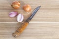 Wooden cutting board with knife and fresh onions Royalty Free Stock Photo