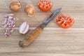 Wooden cutting board with knife, fresh onions and tomatoes Royalty Free Stock Photo