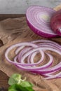 Wooden cutting board on old wooden table top with tablecloth, sliced red onion and cucumber and corn salad Royalty Free Stock Photo