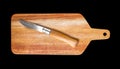 Wooden cutting board and pocket knife isolated on black Royalty Free Stock Photo