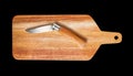 Wooden cutting board and pocket knife isolated on black Royalty Free Stock Photo