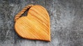 Wooden cutting board in the shape of a heart on a gray background Royalty Free Stock Photo