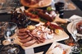 Wooden cutting board with a variety of cured meats.