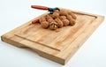 Wooden cutting board with walnuts and nutcracker Royalty Free Stock Photo