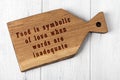 Wooden cutting board with wise inscription about food