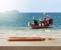 Wooden cuttingboard on table for standing product against sea landscape