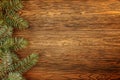 Wooden dark background for Your Christmas titles. Branches of blue spruce.