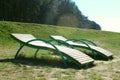 Wooden daybed place on the grass beside forest like.