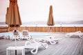 Wooden deck beach sea ocean resort sun lounger umbrella hotel pool sky sunrise. Royalty Free Stock Photo