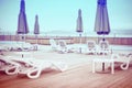 Wooden deck beach sea ocean resort sun lounger umbrella hotel pool sky sunrise. Royalty Free Stock Photo