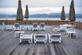 Wooden deck beach sea ocean resort sun lounger umbrella hotel pool sky sunrise. Royalty Free Stock Photo