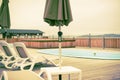 Wooden deck beach sea ocean resort sun lounger umbrella hotel pool sky sunrise.