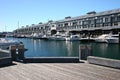 Adaptive reuse of building converted from industrial pier long building at marina with yachts, Woolloomooloo, Sydney, Australia