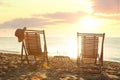 Wooden deck chairs and drinks near sea at sunset. Summer vacation Royalty Free Stock Photo