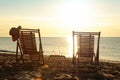 Wooden deck chairs and drinks near sea at sunset. Summer vacation Royalty Free Stock Photo