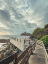 Wooden deck with straw beach umbrellas and sunset view Royalty Free Stock Photo