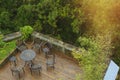 Wooden deck surrounded by trees with seating arrangement