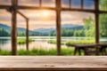 Wooden deck table with the house yard and a lake blurred background. Royalty Free Stock Photo