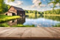 Wooden deck table with the house yard and a lake blurred background. Royalty Free Stock Photo