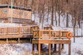 Wooden deck in a wooded area covered in snow Royalty Free Stock Photo