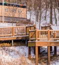 Wooden deck in a wooded area covered in snow Royalty Free Stock Photo