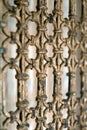 A wooden decoraive beautiful lattice on the doors of gold color. Background of decorative lattice in a shallow depth of field. Vin