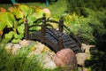 Wooden decorative bridge among stones