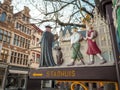 Wooden decorative road sign to the city hall of Mechelen in traditional medieval design next to the main square, Mechelen, Belgium