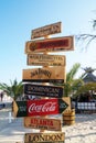 Wooden decorative signage pointers on the pillar on the beach