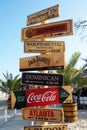 Wooden decorative signage pointers on the pillar on the beach