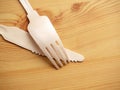 Wooden degradable fork and knife on a light wood table surface, Concept ecology and recycle issue