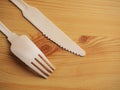 Wooden degradable fork and knife on a light wood table surface, Concept ecology and recycle issue