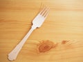 Wooden degradable fork on a wooden surface. Concept Ecology and recycle issue