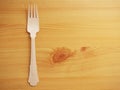 Wooden degradable fork on a wooden surface. Concept Ecology and recycle issue