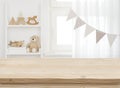 Wooden desk on blurred child room or kindergarten interior background Royalty Free Stock Photo