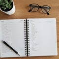 A wooden desk with an open spiral-bound notebook showing a dictionary or language Royalty Free Stock Photo