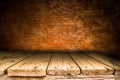 Wooden desk platform and brick wall background Royalty Free Stock Photo